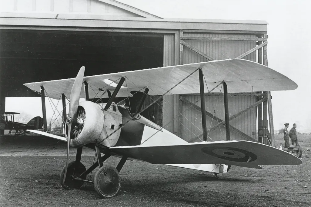 A Sopwith Camel, World War I fighter, seen outside a hangar