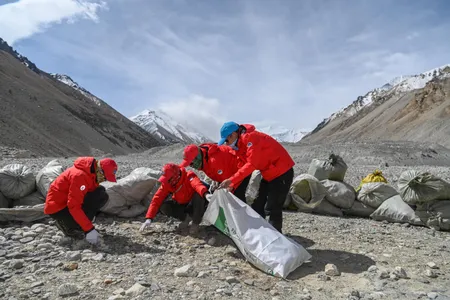 Climbers collect garbage from Mount Everest in 2020. In recent years, officials have implemented new regulations to help reduce trash on the mountain.