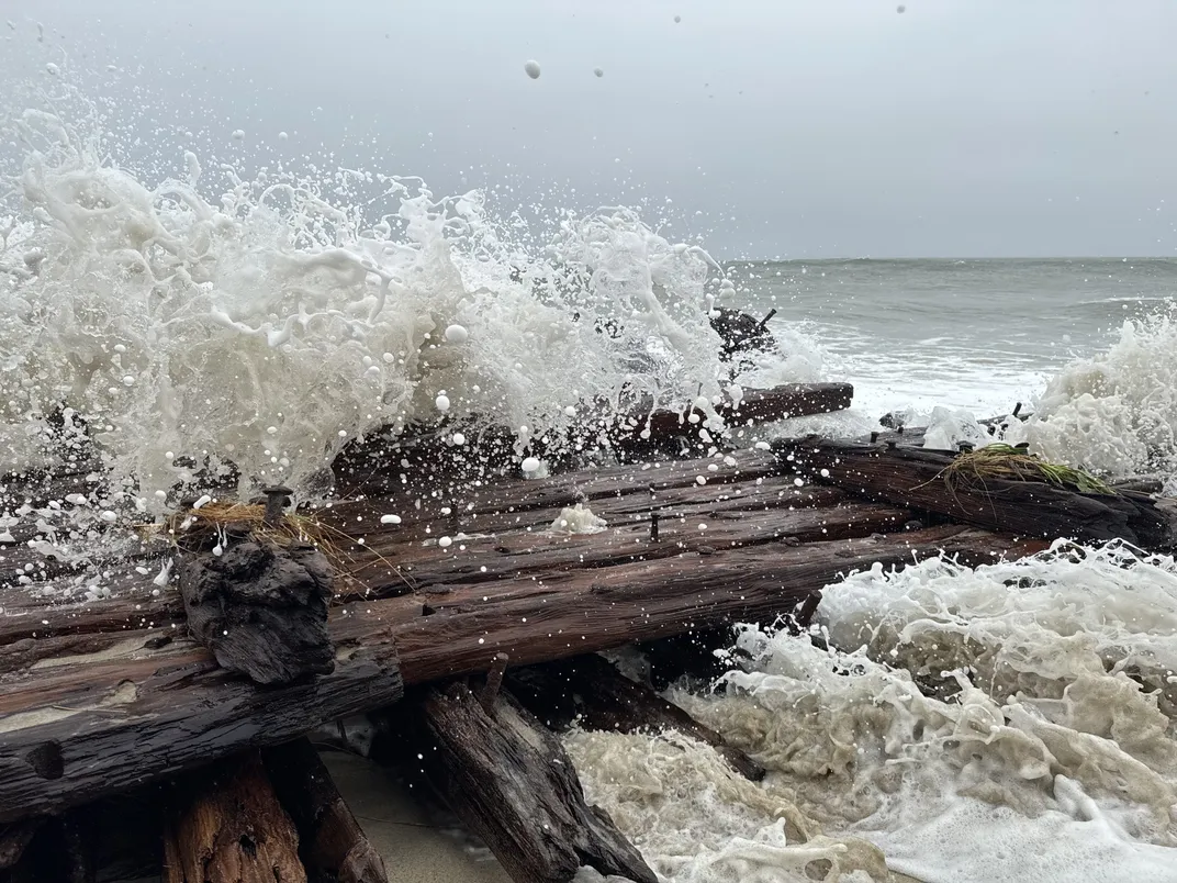 Waves crashing down on a piece of wood