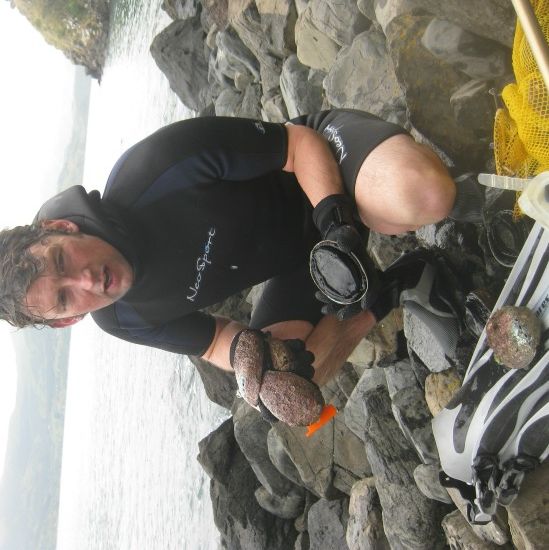 Andrew Bland, brother of the author, shivers and shakes after a frigid abalone, or paua, dive in Akaroa Harbour.