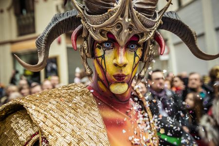 Fictitious Catalan figures known as "carnestoltes" dance in the street during the Carnival parade in Sitges, Spain.