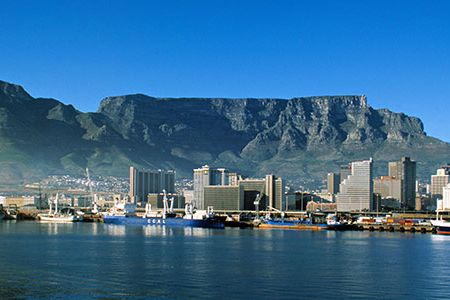 Table Mountain is a flat-topped granite and sandstone massif that rises 3,562 feet above Cape Town, South Africa.