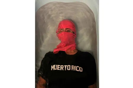 A mask and a wary eye reflects the current conditions of the global pandemic in the  2017 award-winning photograph Muerto Rico by ADÁL.