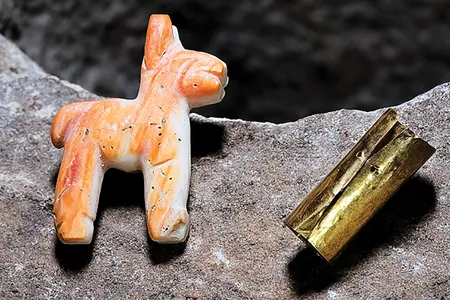 A box of offerings included a gold band reminiscent of a miniature bracelet and a llama or alpaca figurine made of the shell of a rare mollusk. 
