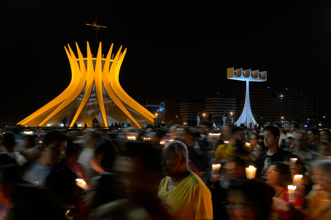 A religious procession takes place in front of the Cathedral of