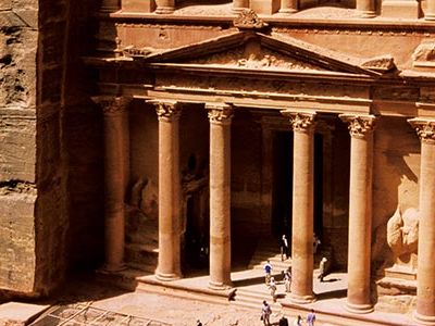 One of the few entryways into Petra is a narrow passage, the Siq, at the end of which Petrans carved elaborate monuments into the soft rock.