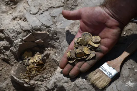 Two volunteers found a cache of 425 gold coins that date back to the ninth century A.D.