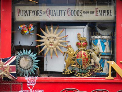 A shop sells nostalgic souvenirs, including a UK coat of arms, at the Portobello Road market in London.