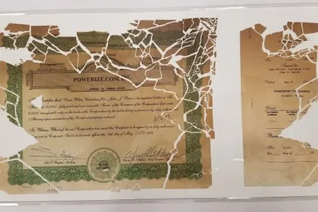 The stock certificate pieced back together and encased in mylar