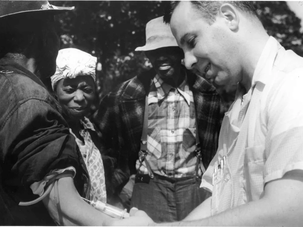 A Tuskegee study subject gets his blood drawn in the mid-20th century.