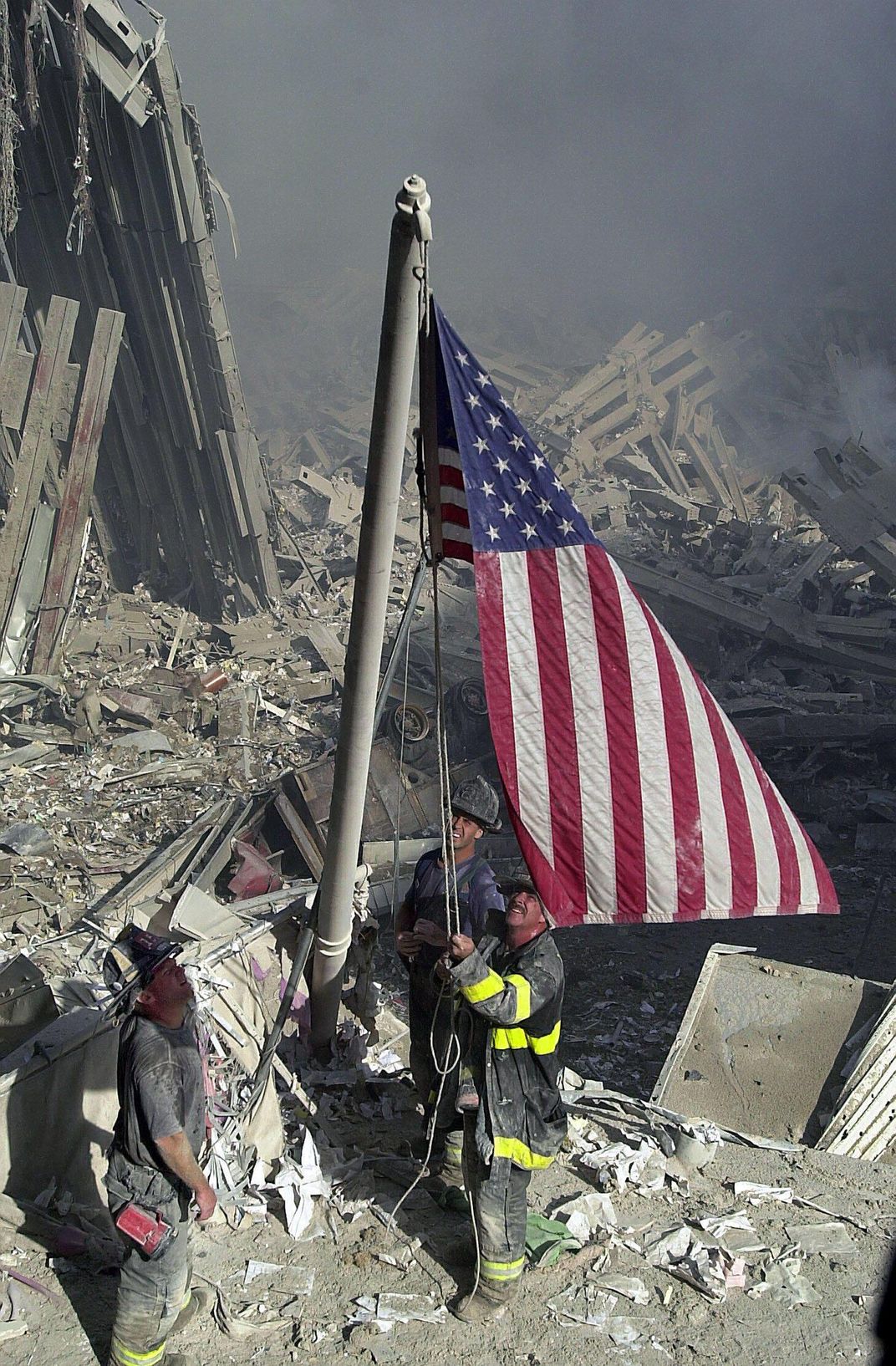 Another view of the same scene, moments after the men successfully raised the flag to the top of the leaning flagpole