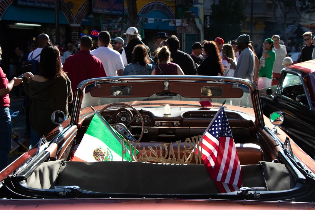 Spanish and American flags shown on a car