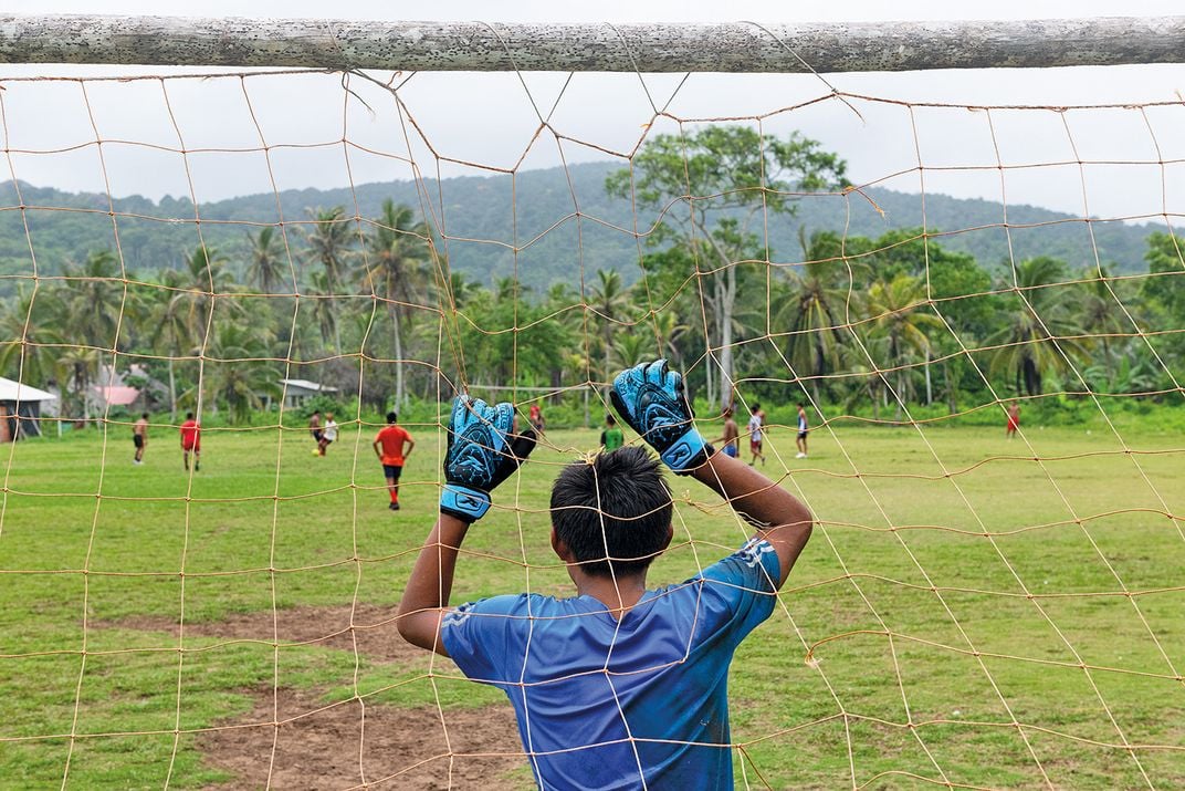 Men and boys play pickup soccer in the Panamanian town of Armila. The village has a population of about 600 Indigenous Guna people.