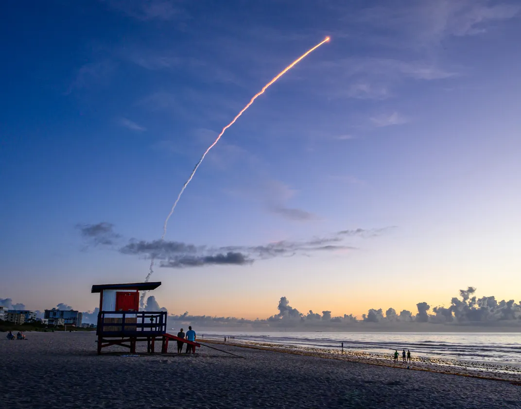 15 - The solid rocket boosters of the United Launch Alliance’s Atlas V 421 rocket display a spectacular vapor trail in the early morning light.