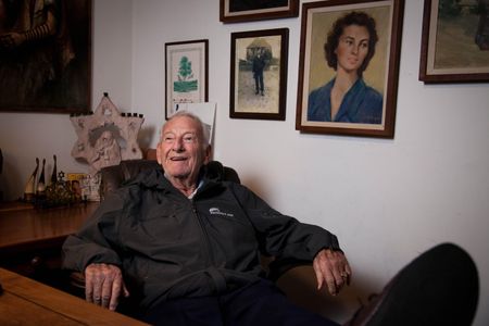 Mel Mermelstein sits in his California home