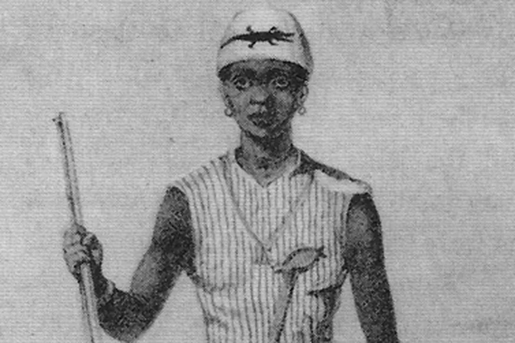 One of Dahomeys' women warriors, with a musket, club, dagger—and her enemy's severed head.