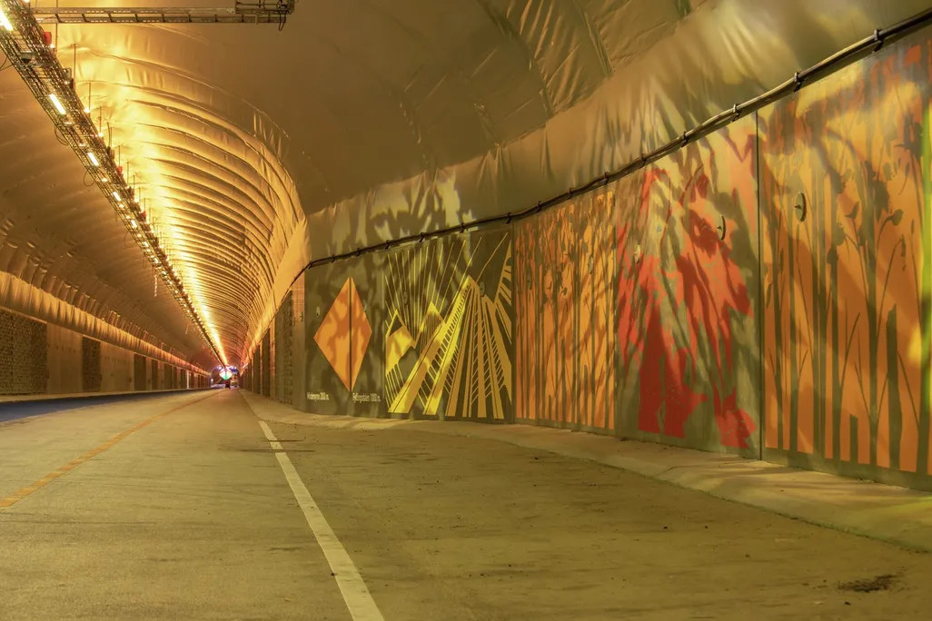 Mural on wall inside dimly lit tunnel