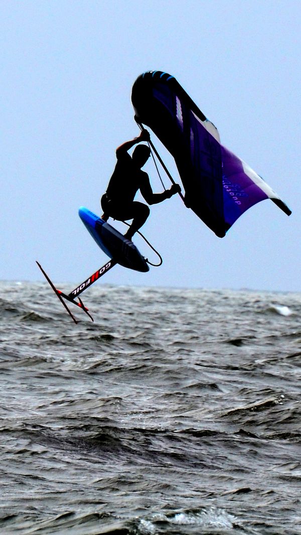 Airborne Wing Surfer in silhouette Off the Coast of Ocean City NJ thumbnail