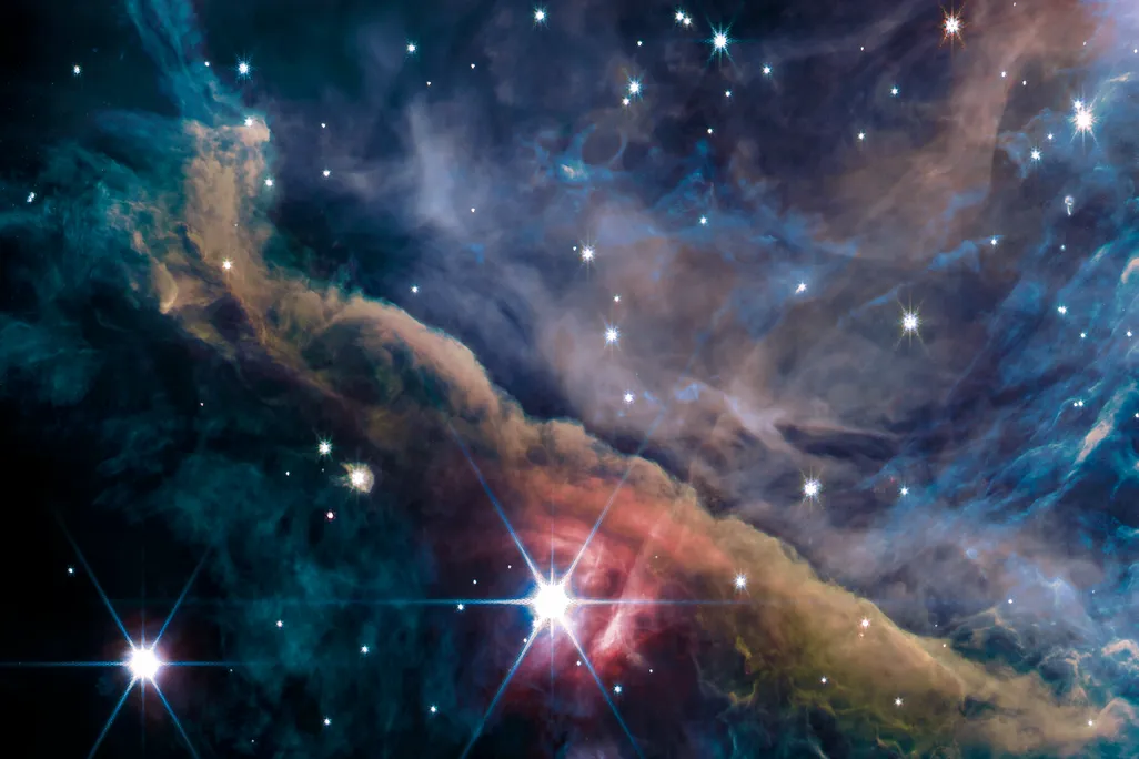 Stars and clouds of blue, purple and brown gas and dust