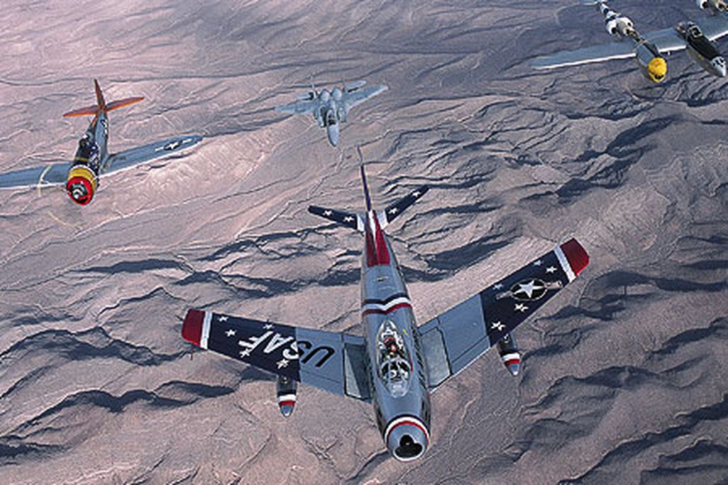 At the 2002 Nellis Air Show near Las Vegas, a Sabre heads up an A team in a USAF Heritage Flight: (from left) P-51 Mustang, P-47 Thunderbolt, F-15 Eagle, P-38 Lightning, and TF-51.