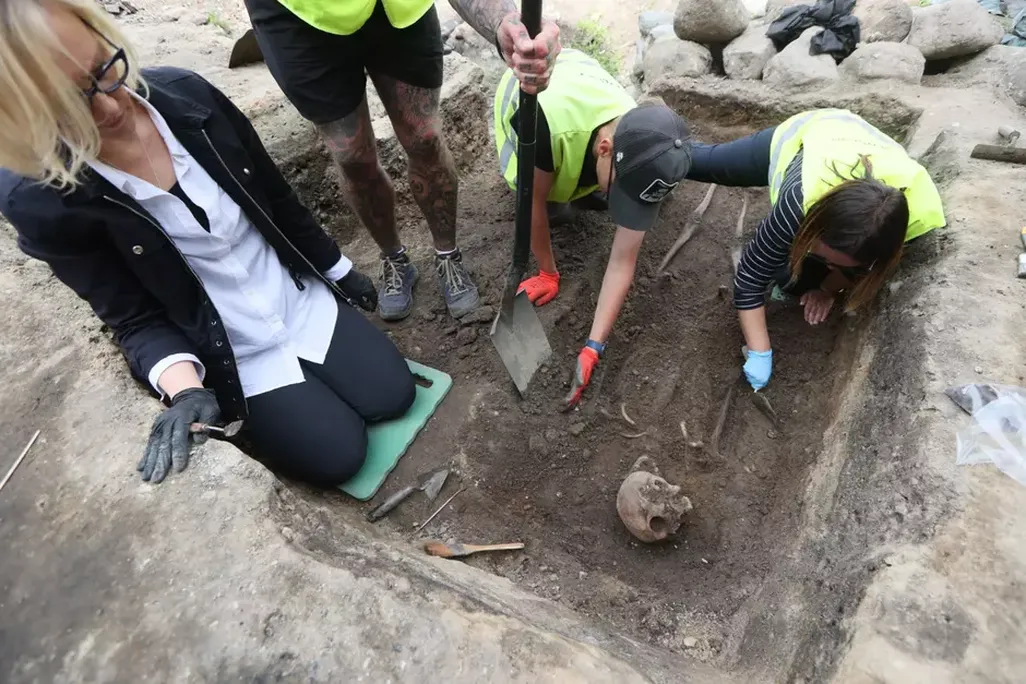 Archaeologists digging in a grave