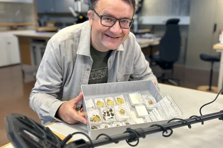 Erlend Bore poses with the trove that he found soon after buying his first metal detector.
