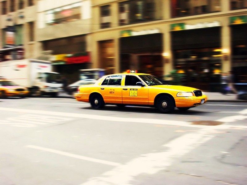 A classic yellow taxi cab strolls through New York. | Smithsonian Photo ...