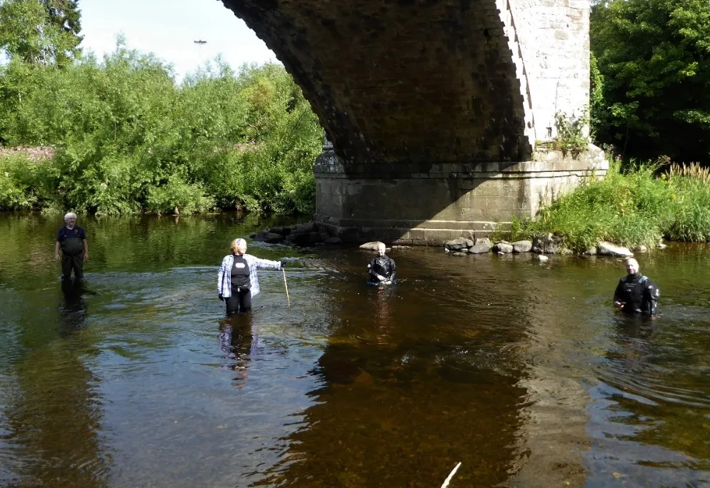 researchers examine the bridge remains