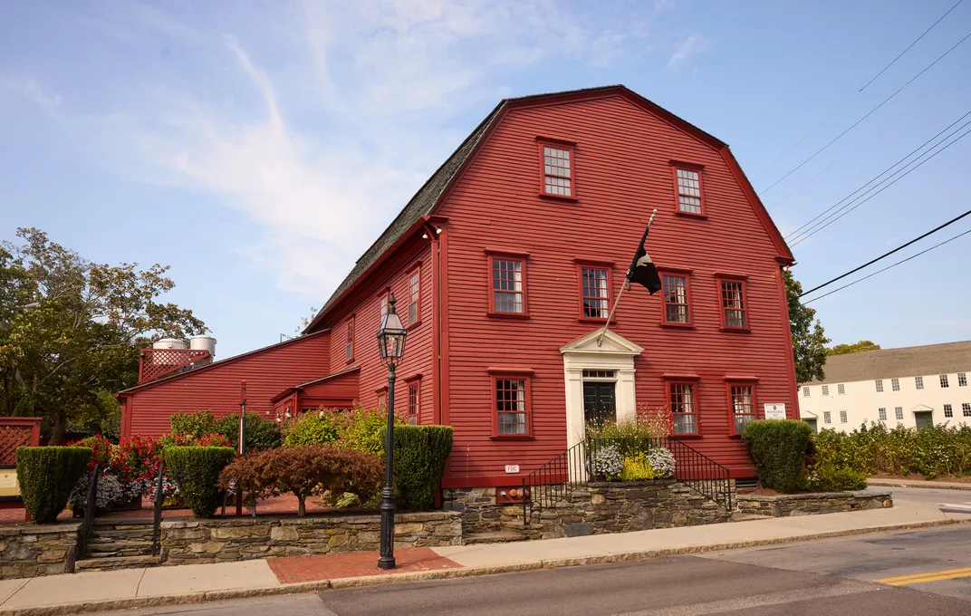 The tavern exterior features a classic New England gambrel roof.