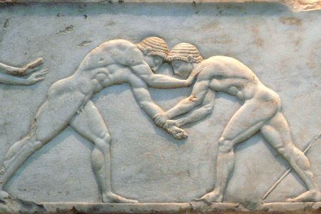Constructed between 510 and 500 B.C., the base of a funerary kouros in Athens is decorated with the image of wrestlers fighting. 