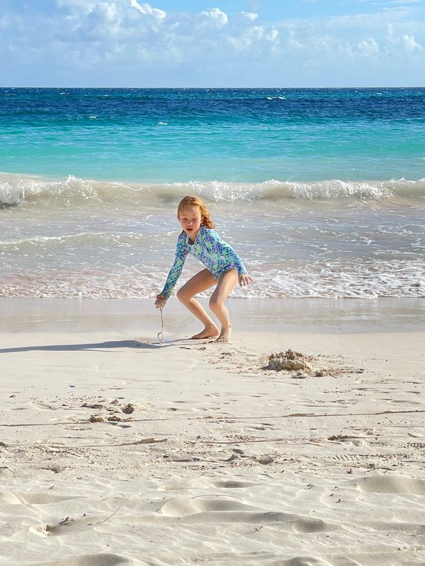 Girl on Beach Running to Her Sand Castle thumbnail