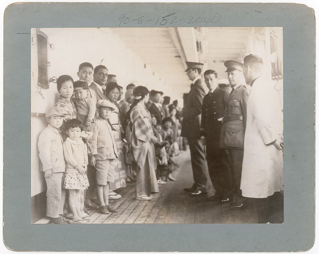 Immigration officers from Angel Island examine passengers aboard a ship off the coast of California in 1931