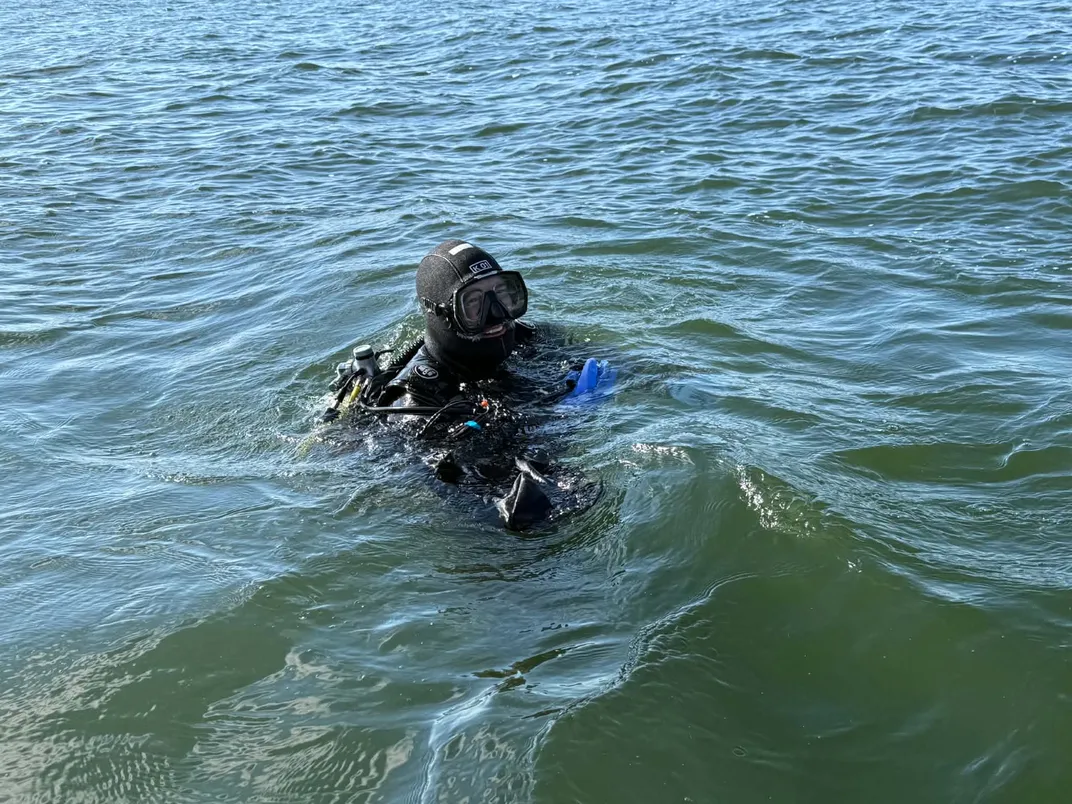 A man in a scuba dive suit in the water