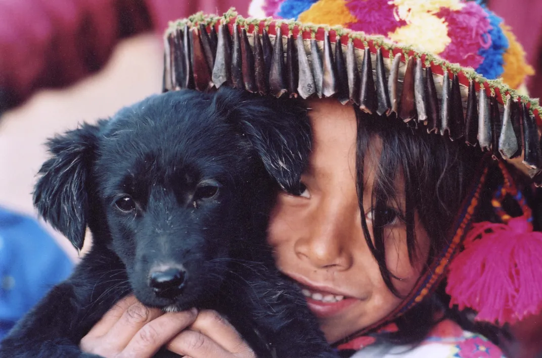 Matchua, a young Wixárika (Huichol) boy, with a black puppy