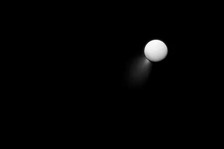 Light reflecting off Saturn illuminates the plumes shooting out of Enceladus in this 2013 Cassini image.