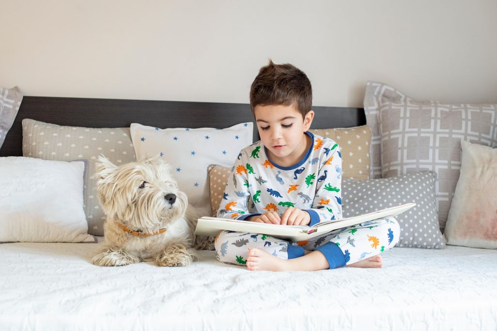 Boy reading with his dog