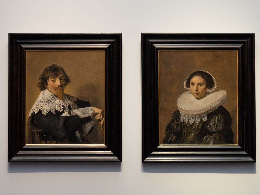 Two portraits hanging side by side on a wall