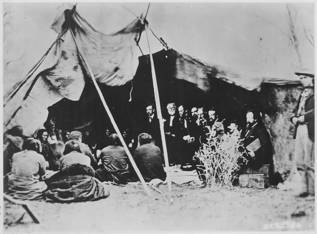 General William Tecumseh Sherman (third from left) and commissioners in council with chiefs and headmen at Fort Laramie in 1868