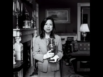 SM_Donna Hayashi Smith, a curator holding a French porcelain vase from 1820.