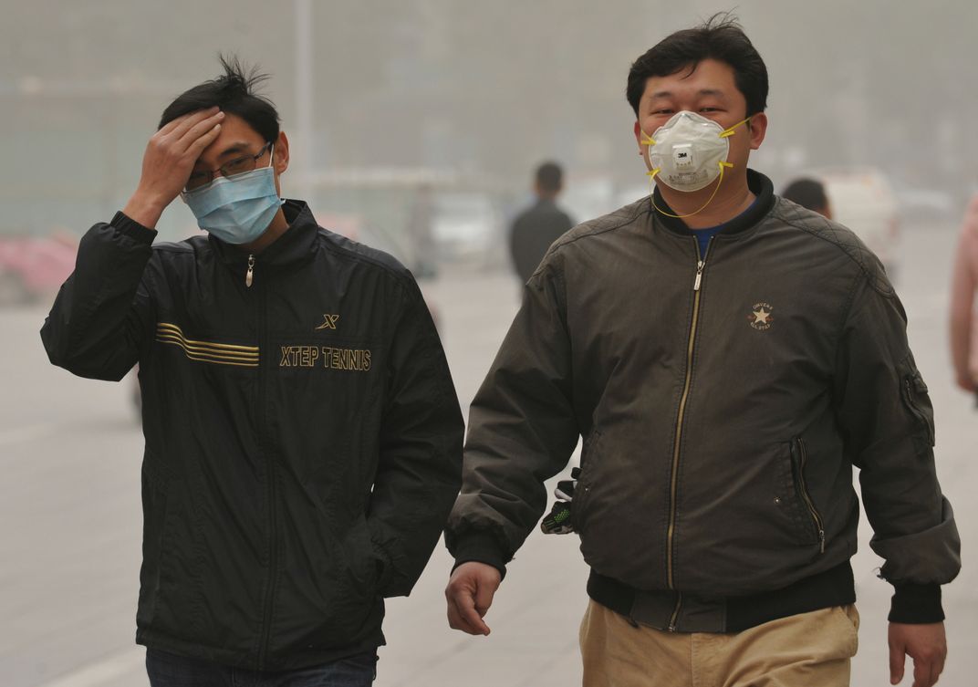 Pedestrians wearing face masks walk on a road in a sandstorm in Korla city, northwest Chinas Xinjiang Uygur Autonomous Region, 23 April 2014. Credit: Imaginechina/Corbis