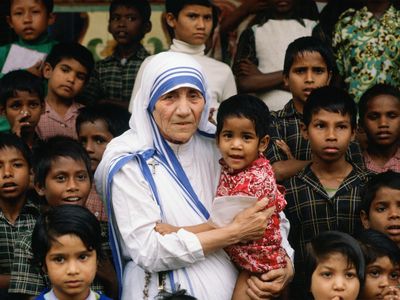 Mother Teresa stands with children at her Calcutta mission.