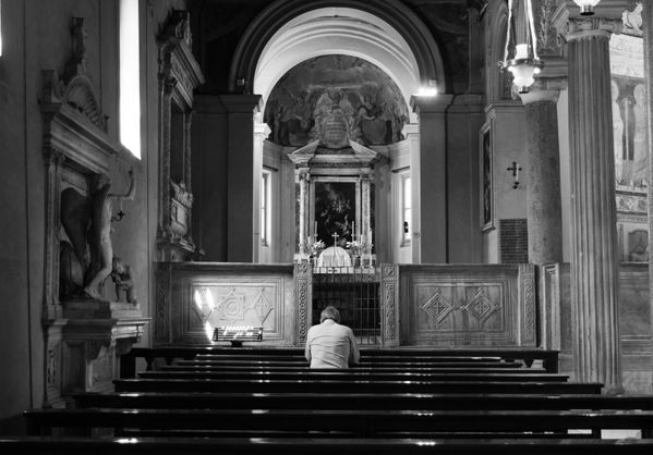 Man praying in Basilica of San Clemente in Rome thumbnail