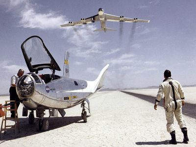 Just another day at the office: Bill Dana with the HL-10 lifting body in 1968, as a B-52 flies overhead.