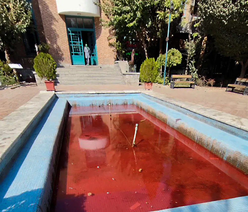 A fountain with its water dyed red outside the Artists' Forum at Honarmandan Park in the Iranian capital Tehran