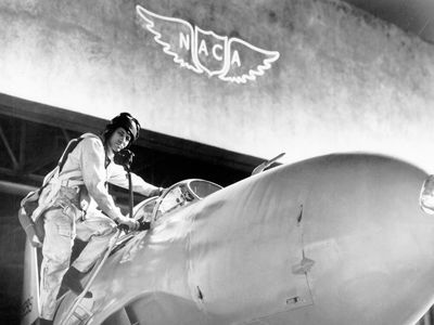 Test pilot Lawrence Clousing with a Lockheed P-80, Moffett Field, California, 1948. Note the NACA emblem, with no periods, on the wall of the Ames Aeronautical Laboratory. 