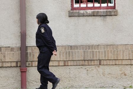 A woman peers out of a residential complex at the women-only Taconic Correctional Facility in Bedford Hills, New York, in 2012.