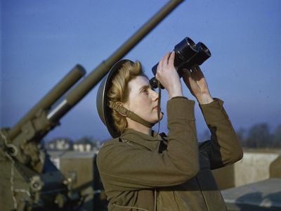 A spotter with binoculars at an anti-aircraft command post. 