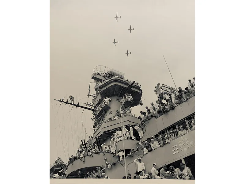 sailors watch as B-29 bombers fly overhead
