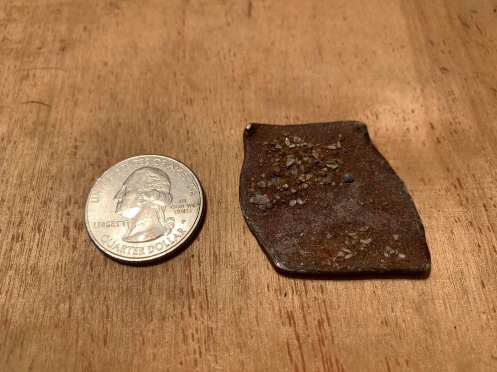 Shipwreck coin next to quarter