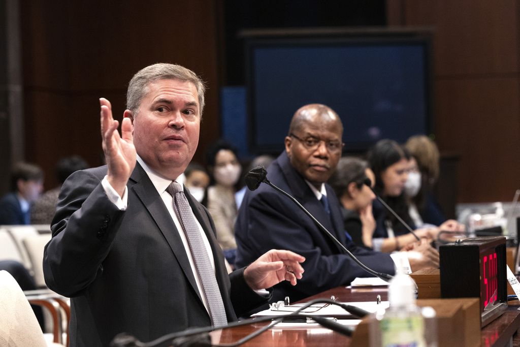 two men seated at a congressional hearing